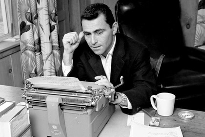 Rod Serling works at a typewriter.