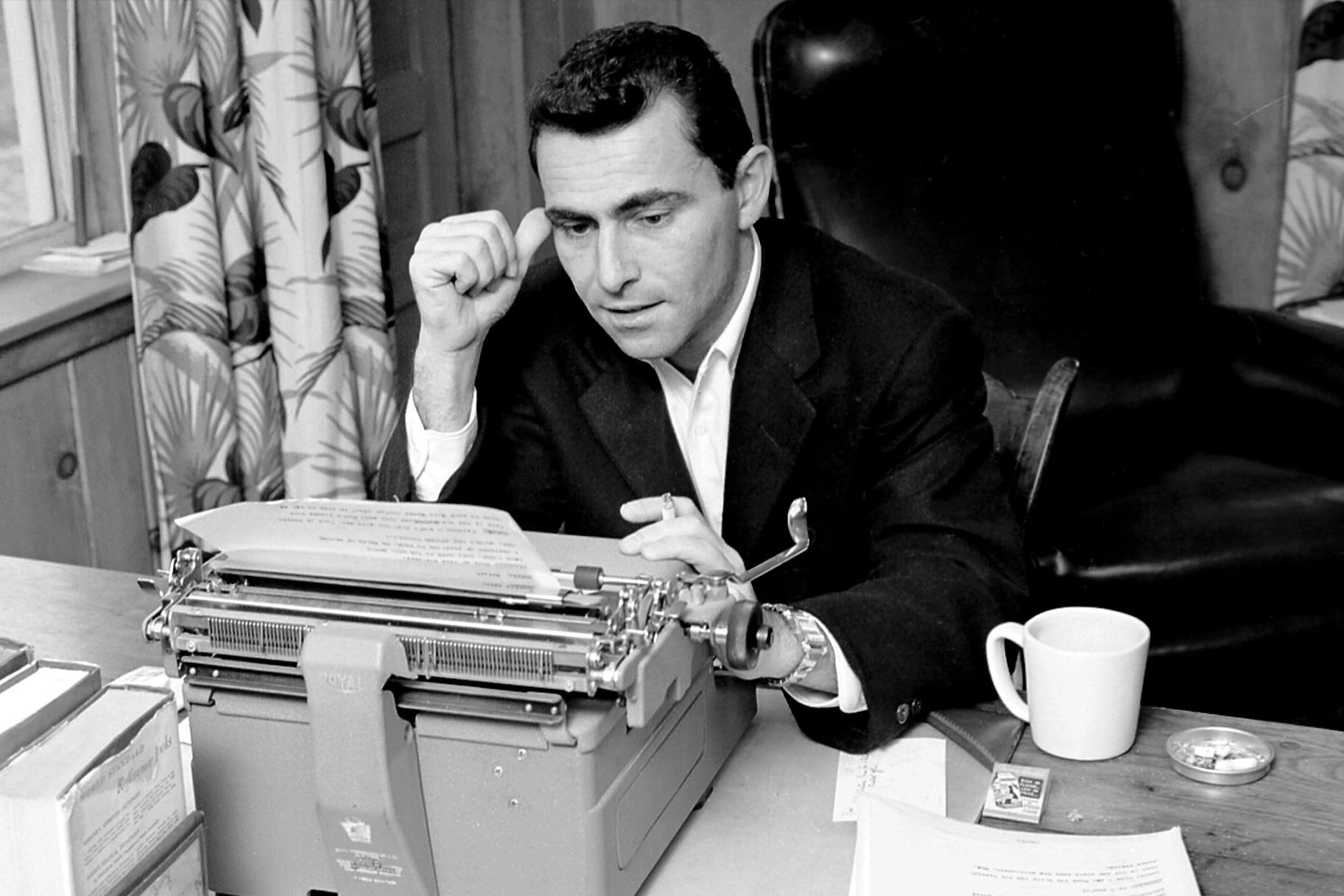 Rod Serling works at a typewriter.