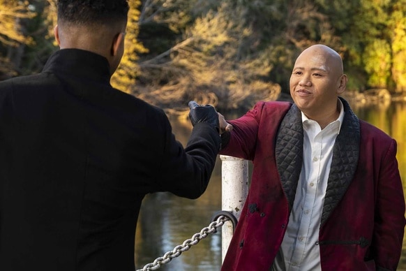 Reginald Andres (Jacob Batalon) fist bumps a man in Reginald the Vampire Episode 201.