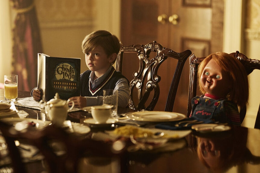 Henry Collins (Callum Vinson) reads a book while dining with Chucky in Chucky 301.