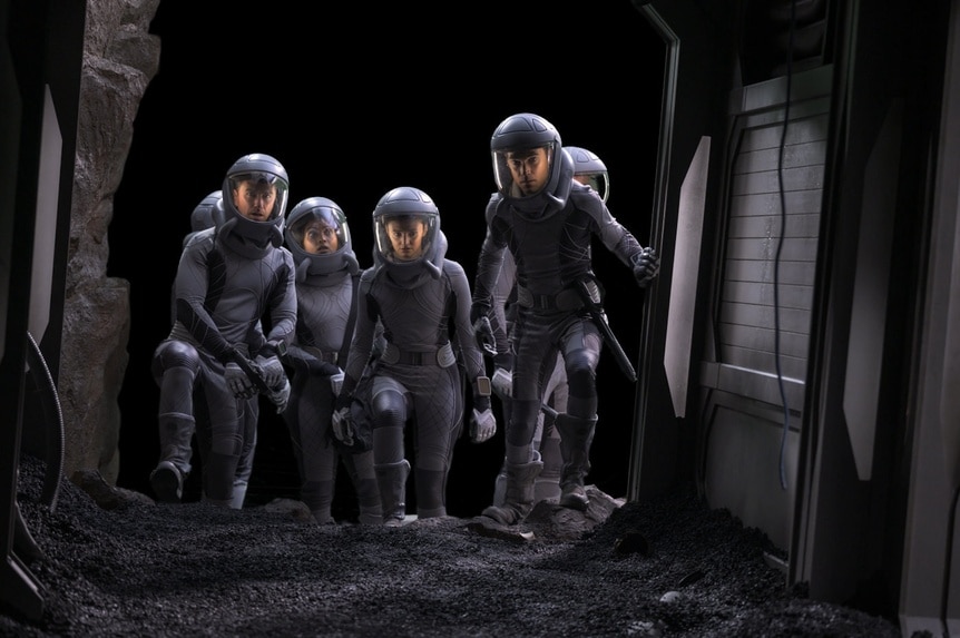 The cast wears full body spacesuits on The Ark Episode 206.