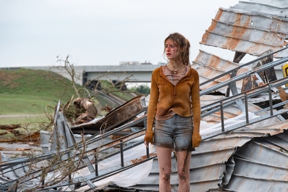 Kate stands on top of a collapsed building in Twisters